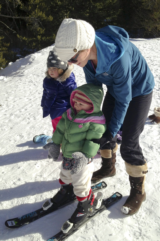 Toddler on skis for the first time.