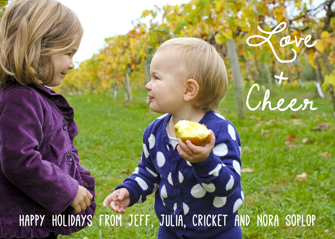 Holiday card portrait: Sisters smiling at each other in a vineyard. 
