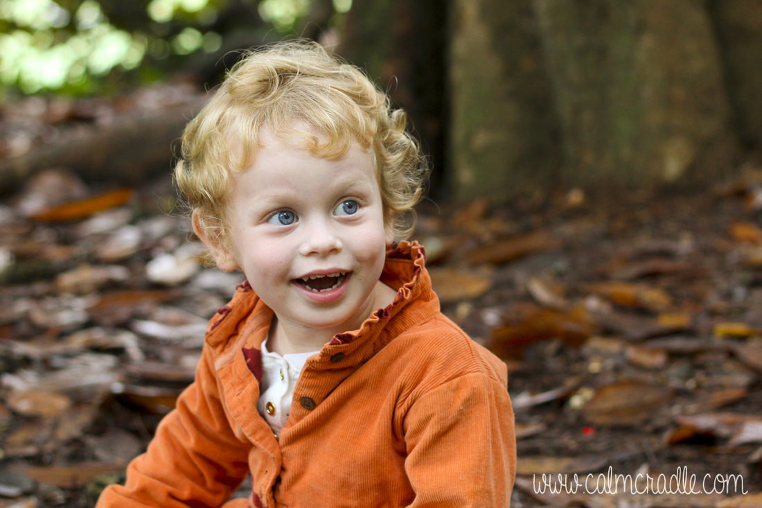 Portraits: Toddler with orange coat at the Sarah P. Duke Gardens. Durham, NC. By Calm Cradle Photo & Design