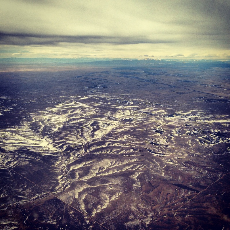 Colorado Rocky Mountains jutting up from the plains in the distance. By Calm Cradle Photo & Design