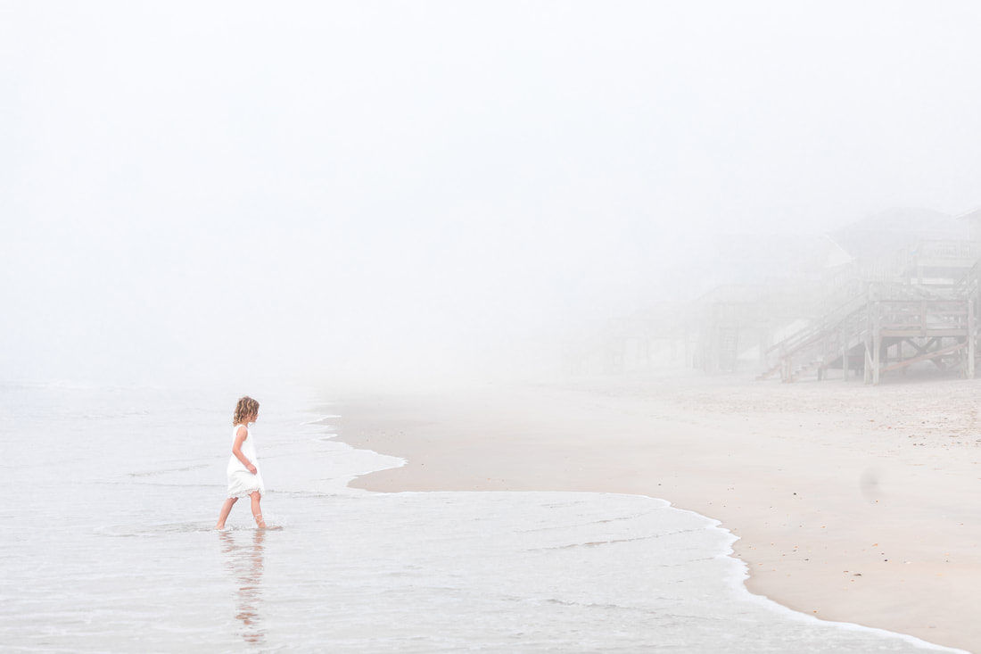 Girl walking on foggy beach. Topsail Island, NC. Lifestyle portraits by Julia Soplop of Calm Cradle Photo & Design. (Chapel Hill, NC)