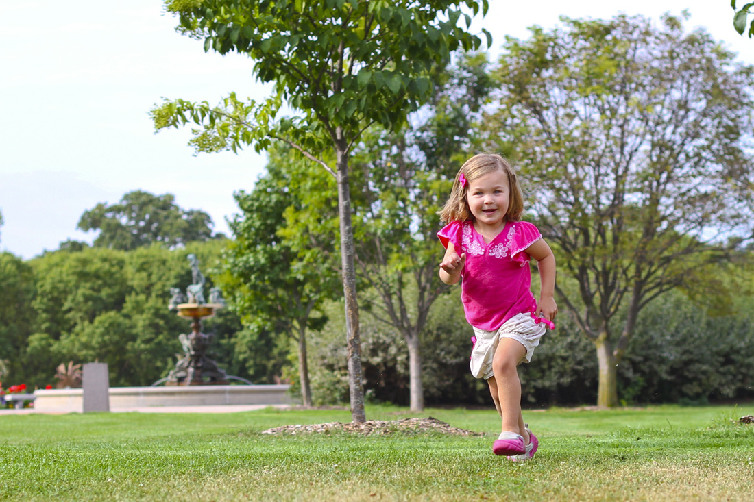 Girl dashing around the Lyndale Park Rose Gardens. Minneapolis, Minnesota (MN). By Calm Cradle Photo & Design