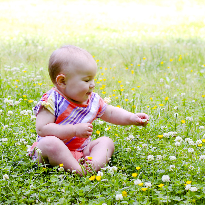 Portraits: 1-year-old in a flower meadow. Calm Cradle Photo & Design