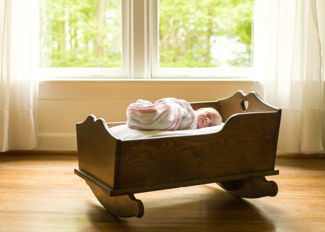 Newborn baby in her grandmother's wooden cradle. By Calm Cradle Photo & Design