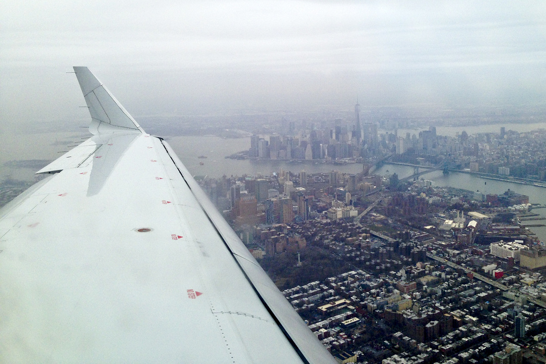 Manhattan off the wing on a cloudy day. New York City. NYC. Photo by Calm Cradle Photo & Design