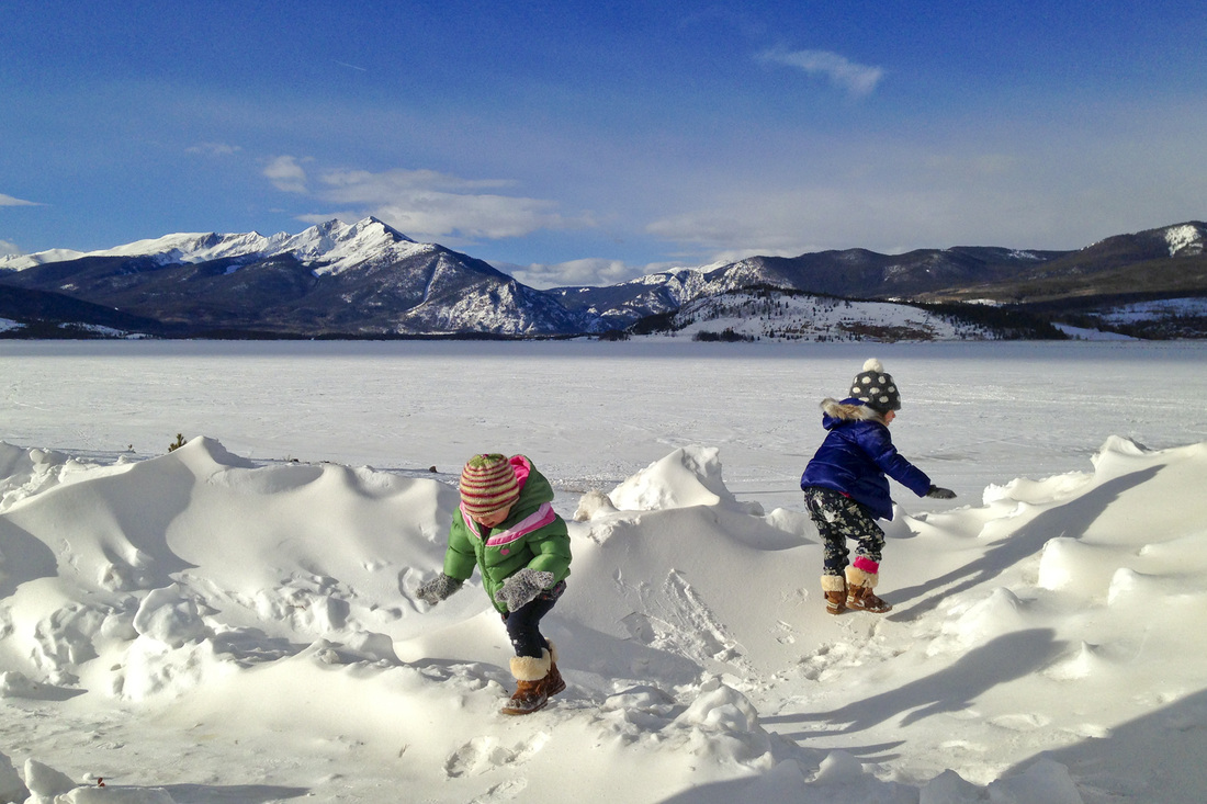 Tots playing on snow drifts. Lake Dillon, Summit County, Colorado. By Calm Cradle Photo & Design