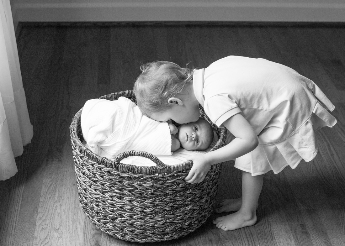 Newborn portraits: Baby and her big sister in their new, empty house. Photography by Calm Cradle Photo & Design
