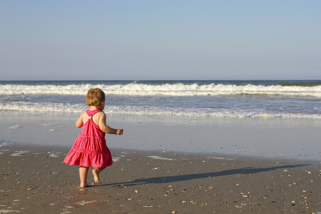 Portraits: Toddler girl running toward water at the beach. By Calm Cradle Photo & Design