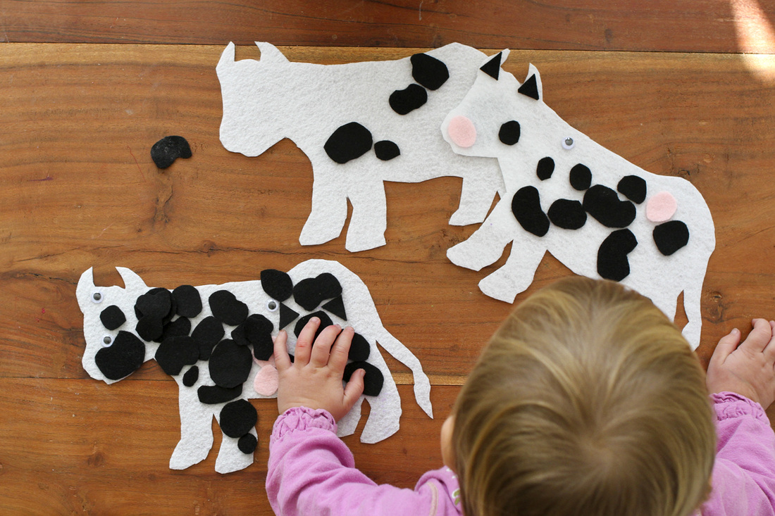 Black, white and pink felt cow decorating activity for cow-themed birthday. By Calm Cradle Photo & Design
