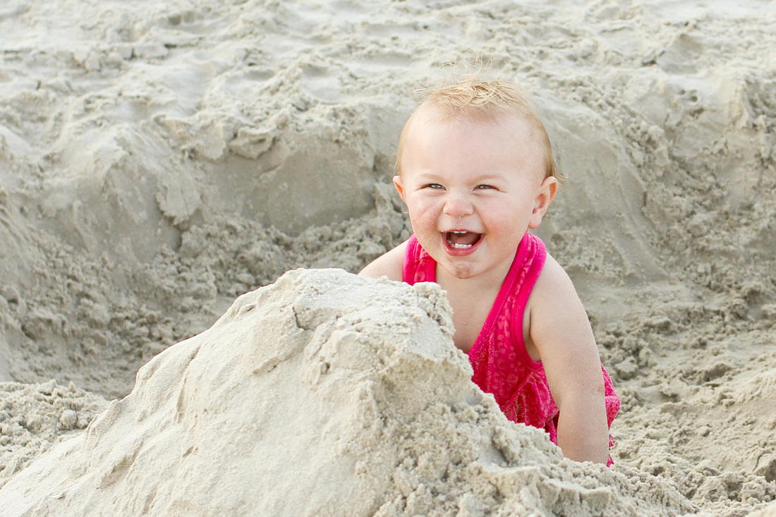 Toddler playing in sand at the beach. By Calm Cradle Photo & Design