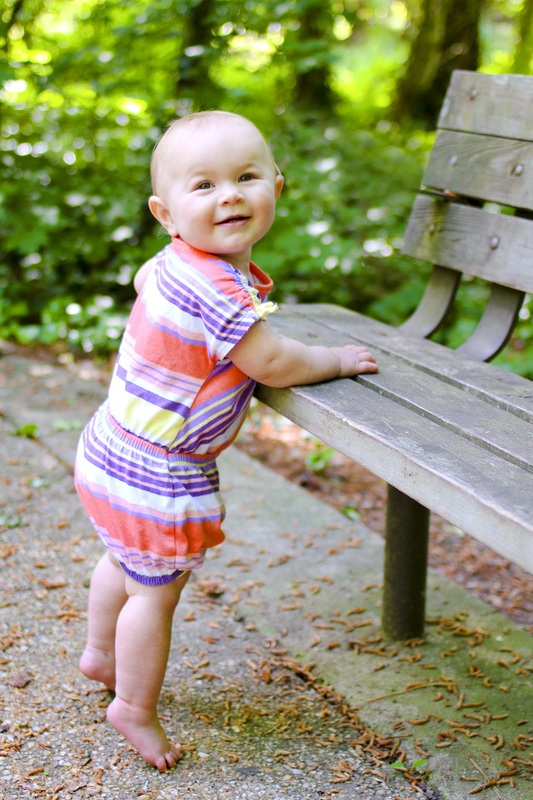 Portraits: 1-year-old standing at a park bench. Calm Cradle Photo & Design