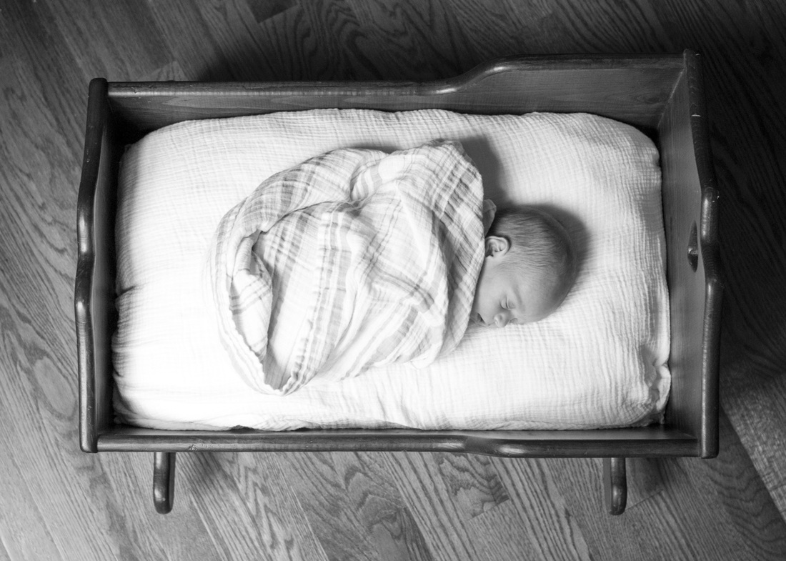 Newborn portraits: Baby sleeping in grandmother's wooden cradle in her new, empty house. Photography by Calm Cradle Photo & Design