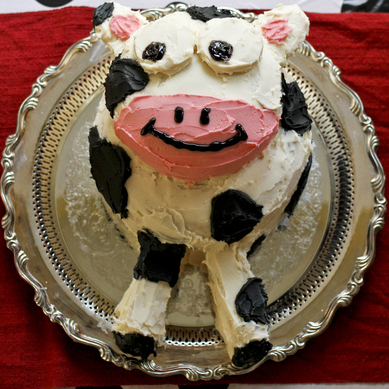 Black, white and pink cow cake for cow-themed 3-year-old birthday party. By Calm Cradle Photo & Design