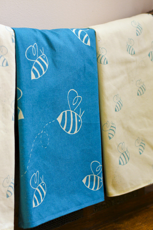 Buzzing bees tea towels in turquoise and custard. By Calm Cradle Photo & Design