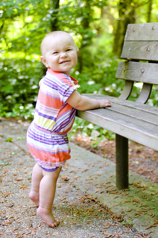 Portraits: 1-year-old standing at a park bench. Calm Cradle Photo & Design