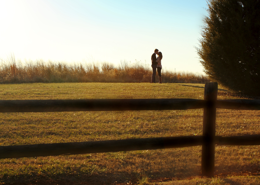 Portraits: Winter engagement photo session in tall grass with fence. By Calm Cradle Photo & Design #engaged #engagement #tallgrass #fence