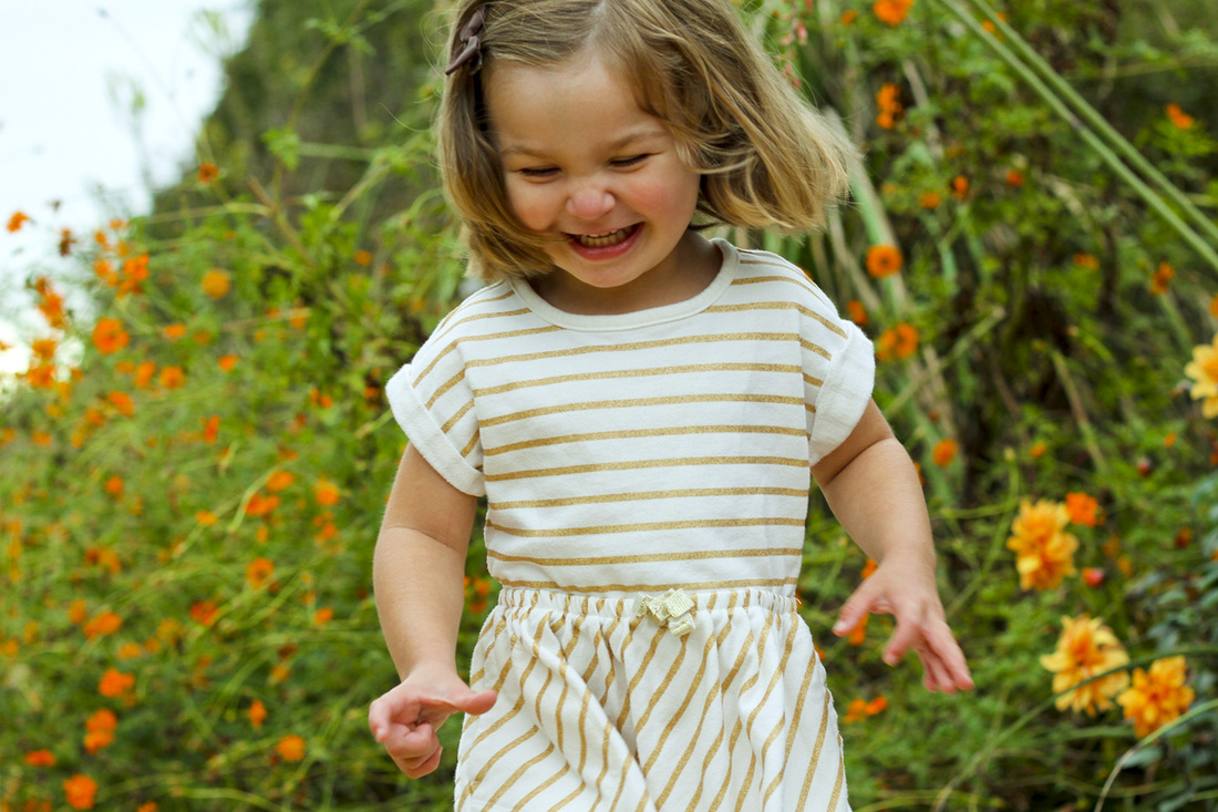 3-year-old portrait. Laughing in the garden. By Calm Cradle Photo & Design