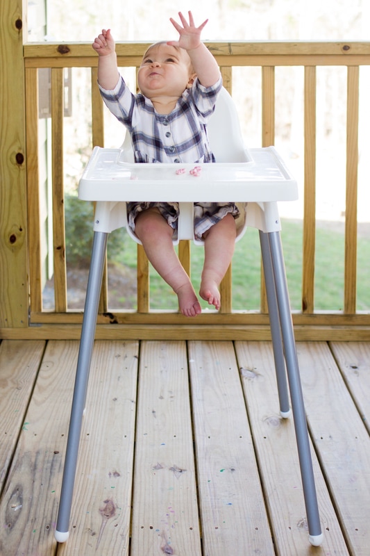 Lifestyle portraits: 10-month-old baby eating in the highchair. By Calm Cradle Photo & Design (Chapel Hill, NC)