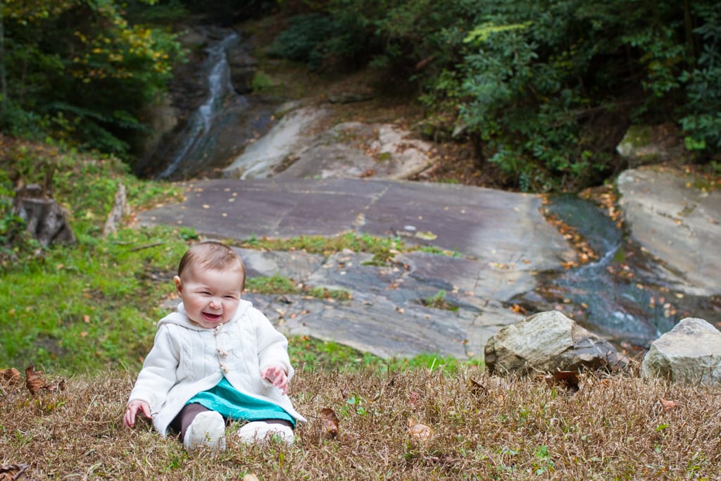 Lifestyle portraits in the Blue Ridge Mountains: Waterfall sitting at 6 months old. Blowing Rock, NC. By Calm Cradle Photo & Design (Chapel Hill, NC)
