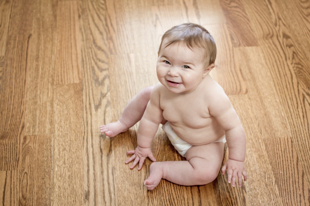 Lifestyle portraits: 7-month-old baby crawling on wood floors. By Calm Cradle Photo & Design (Chapel Hill, NC)