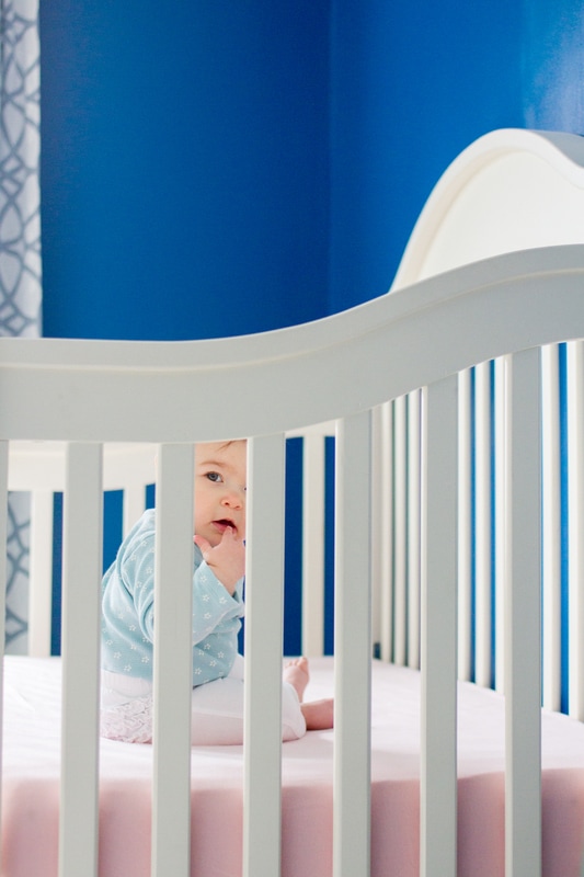 Lifestyle portraits: On creating context in a documentary style. 8 months old in her crib. Baby session by Calm Cradle Photo & Design. (Chapel Hill, NC).